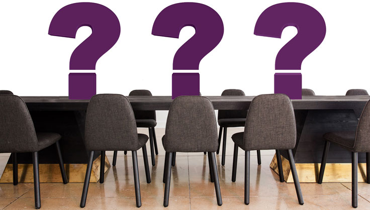 question marks on conference table.