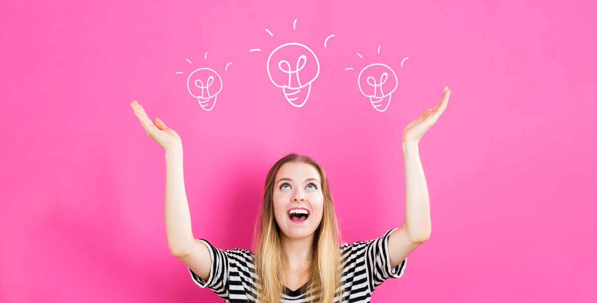 happy woman on magenta background is tossing around ideas for social media.