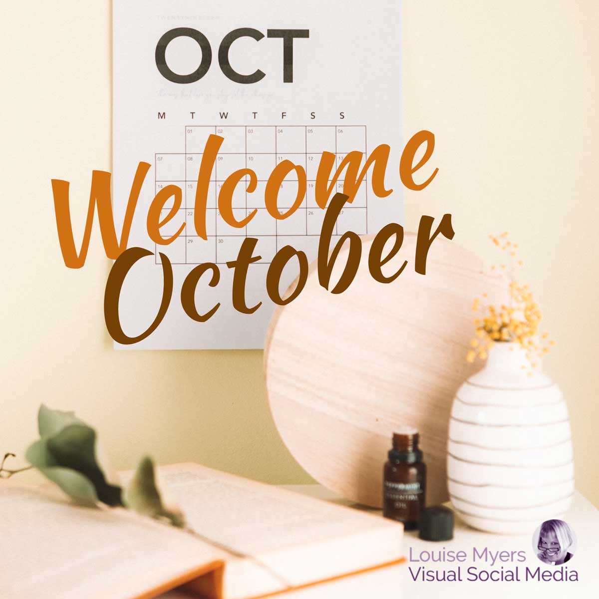 october calendar hangs on wall with script saying welcome october.